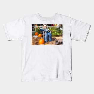 Halloween Mannequin in with ugly mask chair outside beside three large orange pumpkins Kids T-Shirt